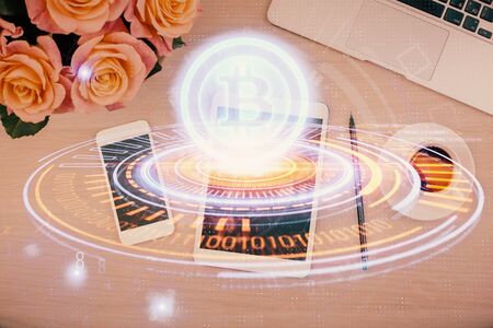 Double exposure of blockchain theme hologram over table with phone. Top view. Crypto technology concept.の写真素材