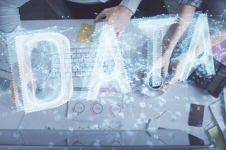 Double exposure of man and woman working together and data theme hologram drawing. Computer background. Top View.の写真素材