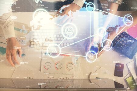 Double exposure of man and woman working together and social network theme hologram drawing. Computer background. connecting concept. Top View.の写真素材