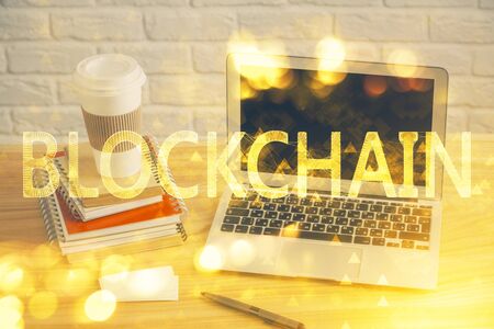 Multi exposure of blockchain theme hologram and table with computer background. Concept of bitcoin...