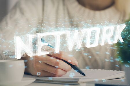 Multi exposure of writing hands on background with data solution hologram. Technology concept.の写真素材