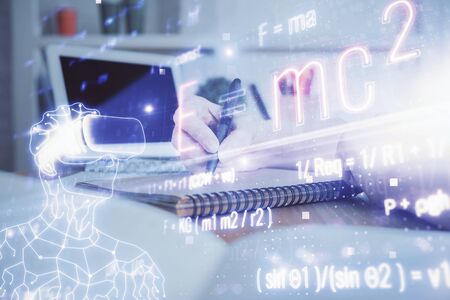 Science formula hologram over woman's hands taking notes background. Concept of study. Double exposureの写真素材