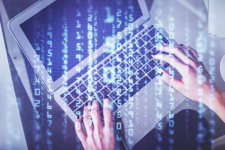 Double exposure of woman hands working on computer and data theme hologram drawing. Top View....
