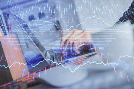 Double exposure of woman hands typing on computer and forex chart hologram drawing. Stock market...