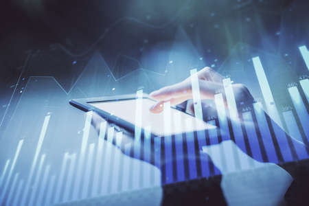 Double exposure of forex chart sketch hologram and woman holding and using a mobile device....