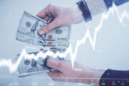 Multi exposure of financial graph drawing hologram and USA dollars bills and man hands. Analysis...