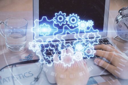 Multi exposure of businessman working on laptop on background. International business hologram in...