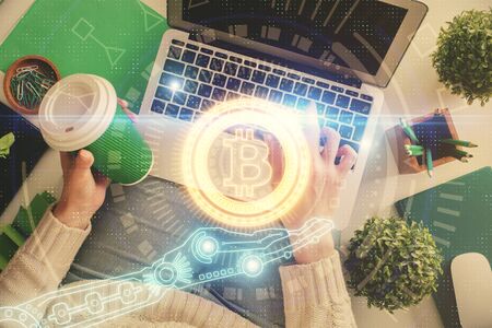 Double exposure of woman hands working on computer and blockchain theme hologram drawing. Top View....