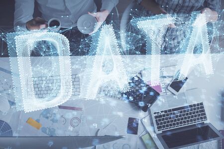 Double exposure of man and woman working together and data theme hologram drawing. Computer background. Top View.の写真素材