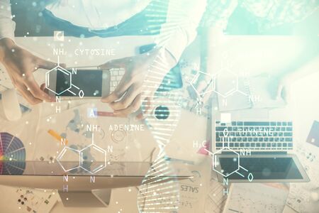 Double exposure of man and woman working together and DNA hologram drawing. Computer background....
