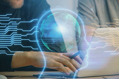 Businessman with computer background with brain theme hologram. Concept of brainstorm. Multi...