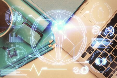 Education hologram drawings over computer on the desktop background. Top view. Multi exposure.の写真素材