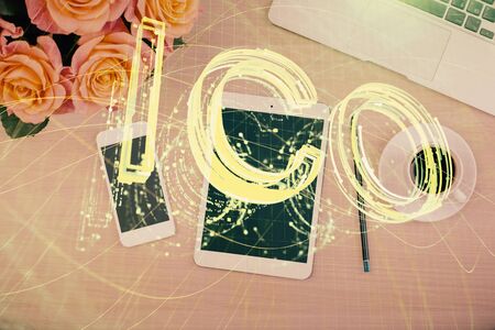Double exposure of blockchain theme hologram over table with phone. Top view. Crypto technology...