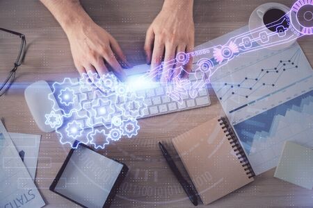 Double exposure of mans hands typing over computer keyboard and data theme hologram drawing. Top...