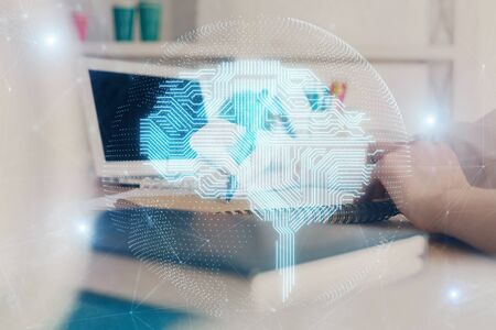 Multi exposure of writing hand on background with brain hologram. Concept of learning.の写真素材