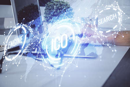 Crypto currency theme hologram with businessman working on computer on background. Concept of...