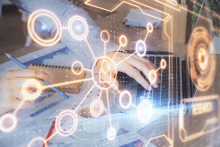 Media network theme hologram with man working on computer on background. Concept of internet...