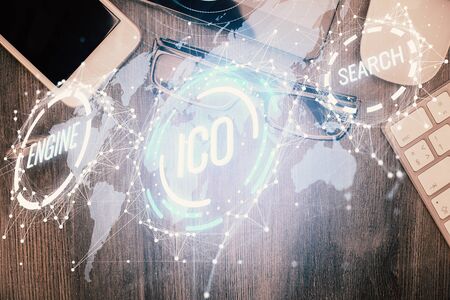 Double exposure of blockchain theme hologram over table with phone. Top view. Crypto technology concept.の写真素材