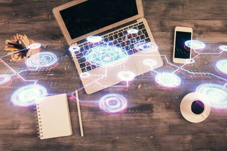 Social network hologram drawings over computer on the desktop background. Top view. Multi exposure. Concept of people connection.の写真素材