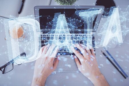 Multi exposure of mans hands typing over computer keyboard and data theme hologram drawing. Top...