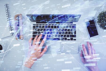 Double exposure of woman hands working on computer and data theme hologram drawing. Top View. Technology concept.の写真素材