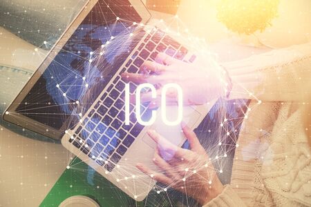 Double exposure of woman hands working on computer and blockchain theme hologram drawing. Top View. bitcoin cryptocurrency concept.の写真素材