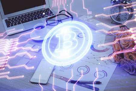 Double exposure of blockchain and crypto economy theme hologram and table with computer background....