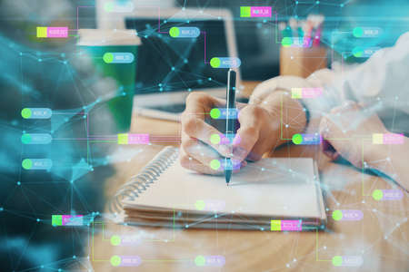 Multi exposure of writing hands on background with data solution hologram. Technology concept.