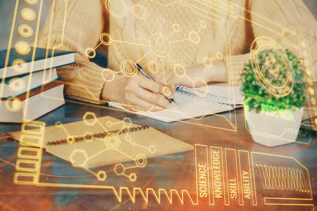 Double exposure of writing hands on background with data solution hologram on front. Technology...