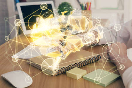 Multi exposure of writing hand on background with brain hologram. Concept of self learning.の写真素材