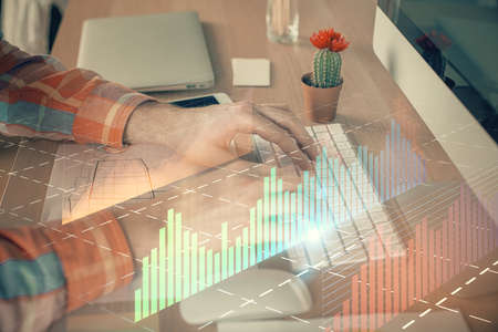 Double exposure of stock market chart with man working on computer on background. Concept of financial analysis.の写真素材
