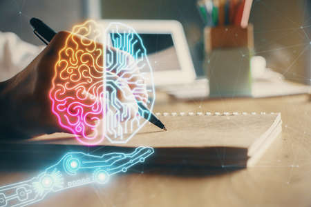 Multi exposure of writing hand on background with brain hologram. Concept of self learning.