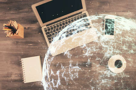 Social network hologram drawings over computer on the desktop background. Top view. Multi exposure. Concept of people connection.の写真素材