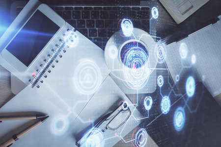 Double exposure of technology theme drawing over work table desktop. Top view. Global data analysis...