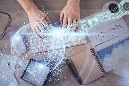 Double exposure of mans hands typing over computer keyboard and data theme hologram drawing. Top view. Technology concept.の写真素材