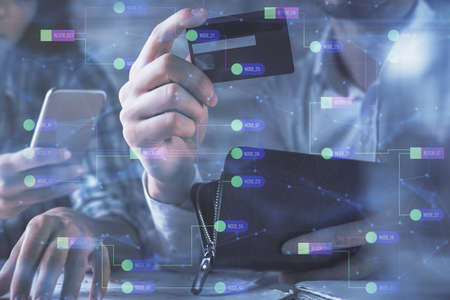 Double exposure of man and woman on-line shopping holding a credit card and data theme hologram...