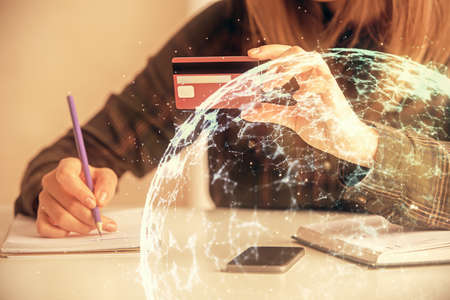 Multi exposure of woman on-line shopping holding a credit card and social network theme drawing. Relationship E-commerce concept.の写真素材