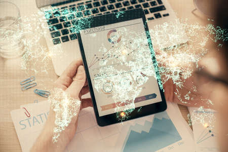 Double exposure of mans hands holding and using a phone and social network theme drawing.
