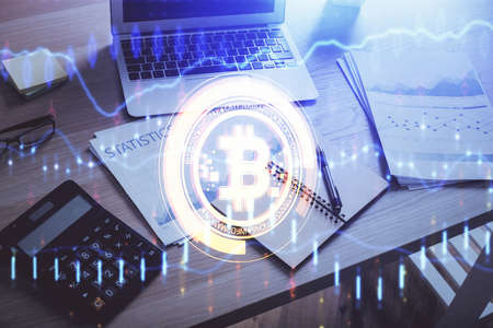 Double exposure of blockchain and crypto economy theme hologram and table with computer background....
