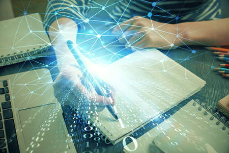 Double exposure of hands making notes with digital coding icons. Computer learning concept.