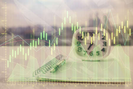 Double exposure of financial graph drawings and desk with open notebook background. Concept of forex...