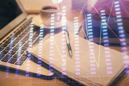 Double exposure of forex chart drawing and desktop with coffee and items on table background....
