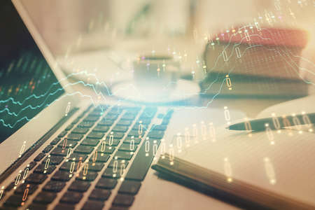 Double exposure of financial chart drawing and desktop with coffee and items on table background....