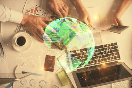 Double exposure of man and woman working together and social network theme hologram drawing. Computer background. connecting concept. Top View.の写真素材