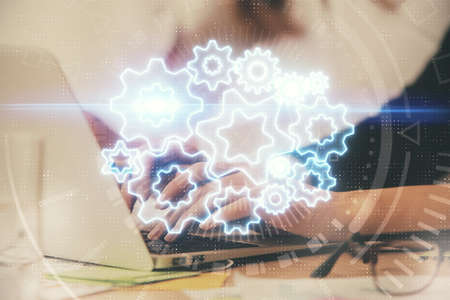 Multi exposure of woman hands typing on computer and business theme hologram drawing. Success...