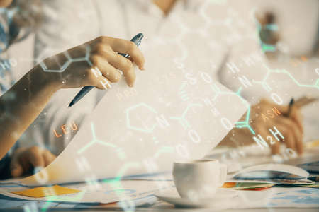 Double exposure of formula drawing over people taking notes background. Concept of education