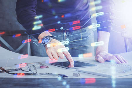 Double exposure of mans hand holding and using a digital device and data theme drawing. Technology...