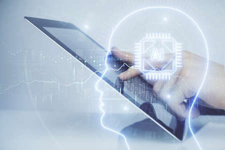 Double exposure of mans hand holding and using a digital device and brain hologram drawing. Data...