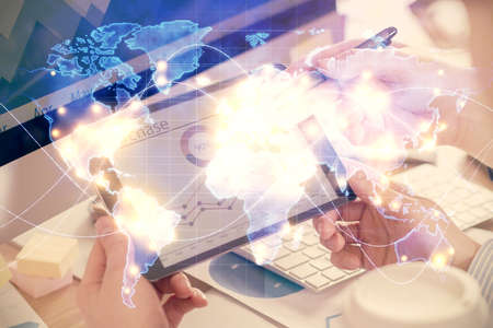 Double exposure of mans hands holding and using a phone and international business theme drawing.