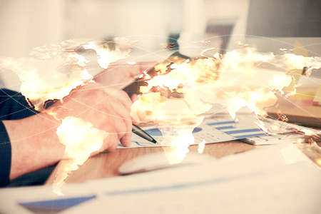 Double exposure of mans hands holding and using a phone and international business theme drawing.の写真素材